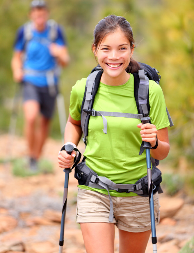 Healthy smiling young woman hiking. Oak Enrichment Concierge Wellness.