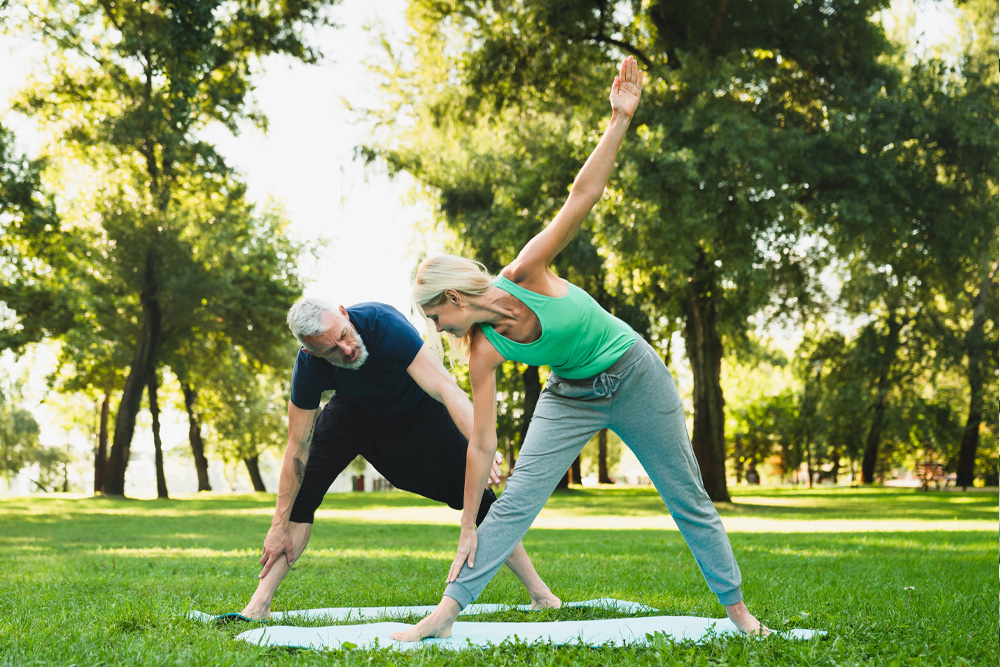 Coaching older man in the park. Oak Enrichment Concierge Wellness.